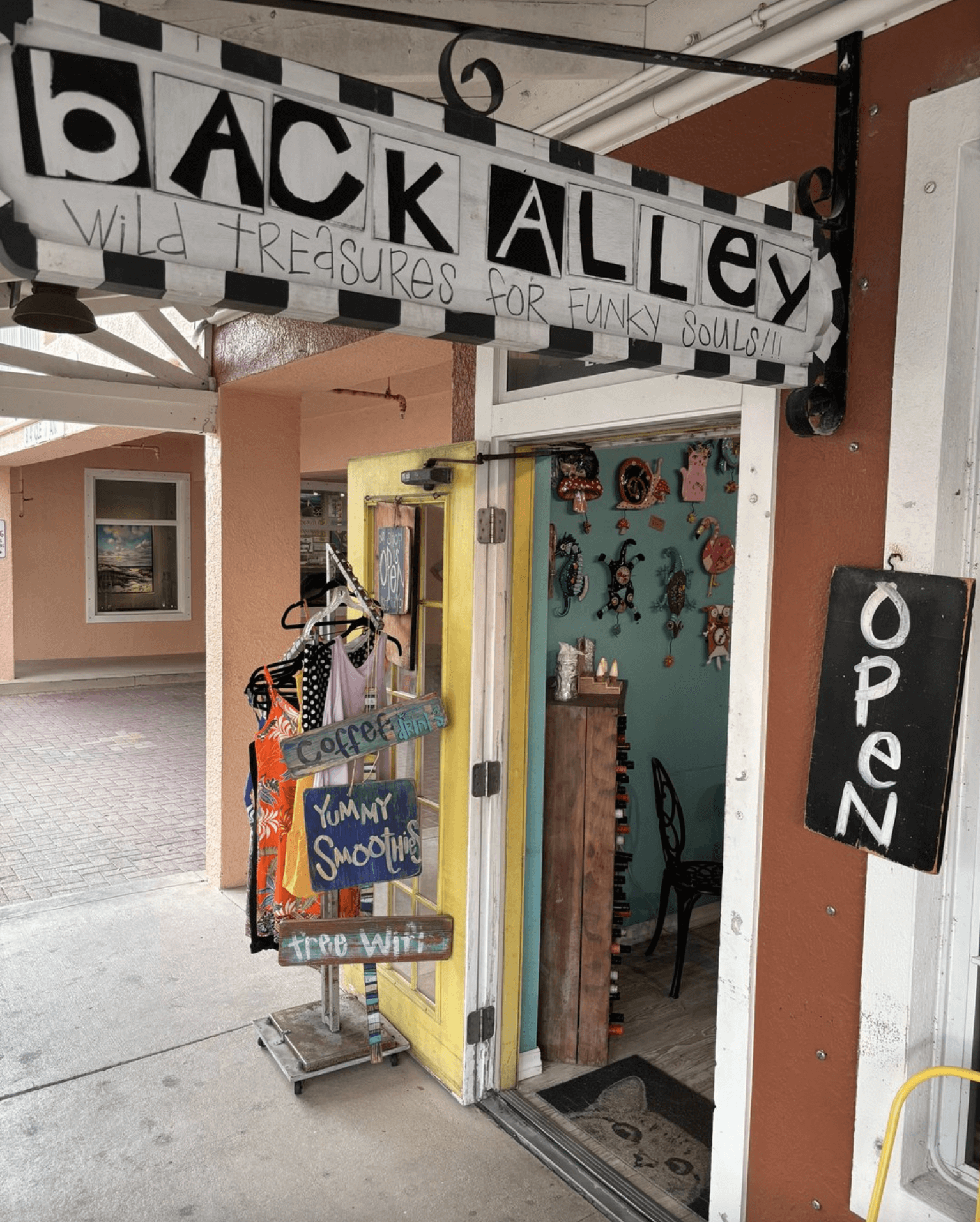 exterior of back alley treasures with local art and clothes on display